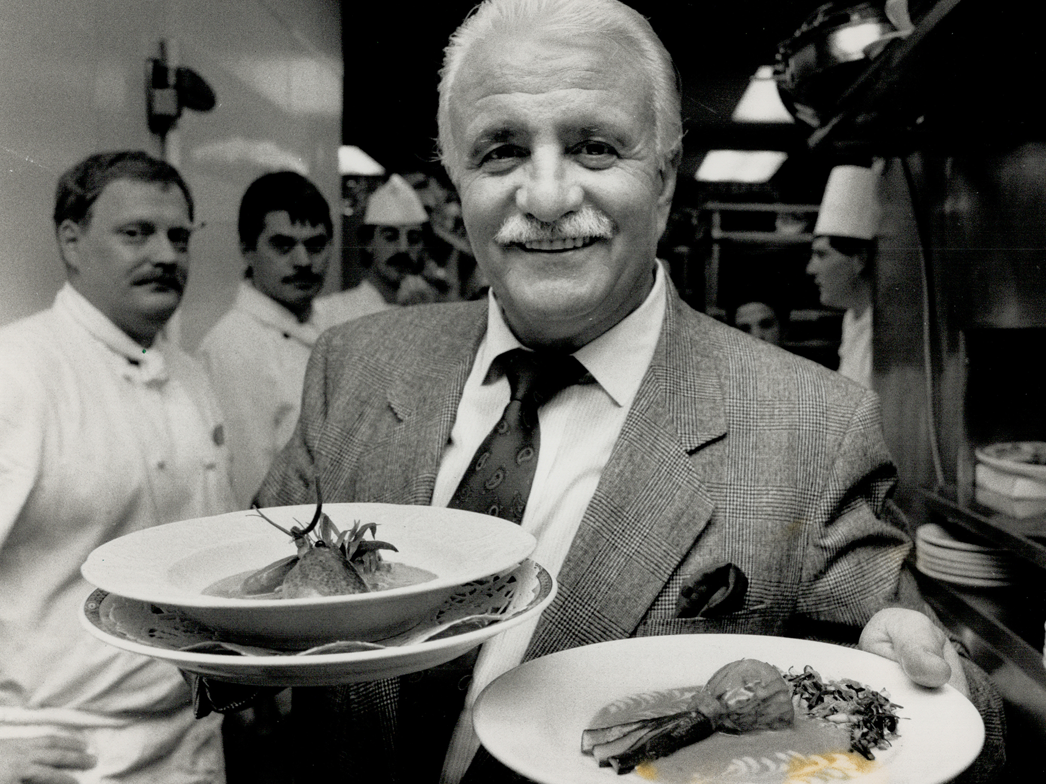 Full Plate: French chef-entrepreneur Roger Verge; in Toronto for a special promotion; holds a fricassee of lobster; left and zucchini blossom stuffed with truffles.